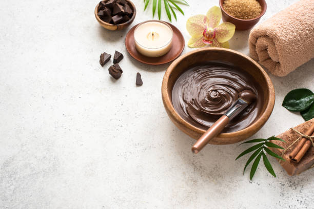 Chocolate Spa Chocolate Spa flat lay on white background, copy space. Natural spa beauty products with chocolate and plants. ritual mask stock pictures, royalty-free photos & images