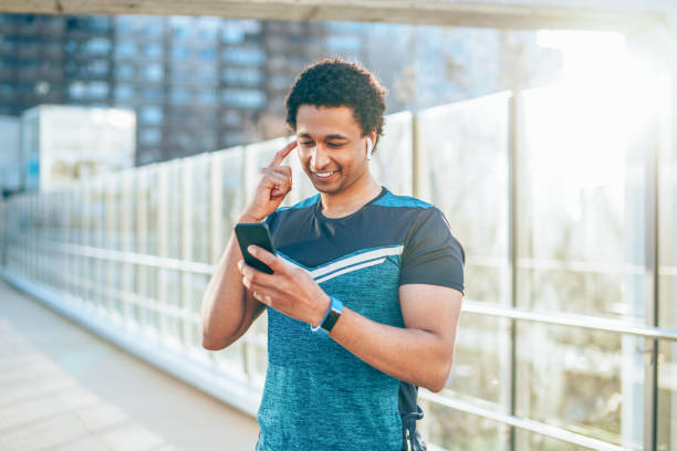 istock Smiling athlete with smart phone 1150887284