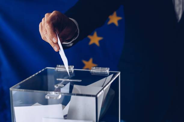 istock Male inserting his vote to ballot box 1150887423