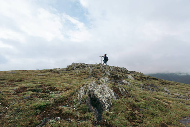istock tourist woman looking at binoculars on a hillside 1150888153