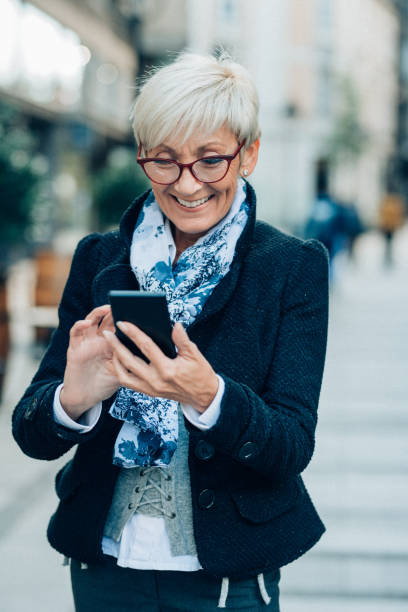 istock Senior woman texting outdoor 1150888578