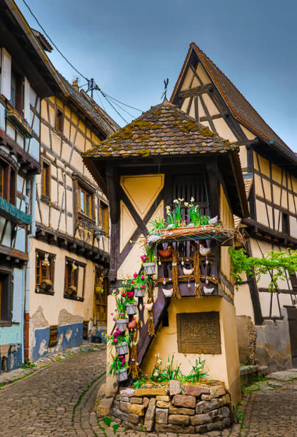 a farmhouse in alsace france with a tractor outside