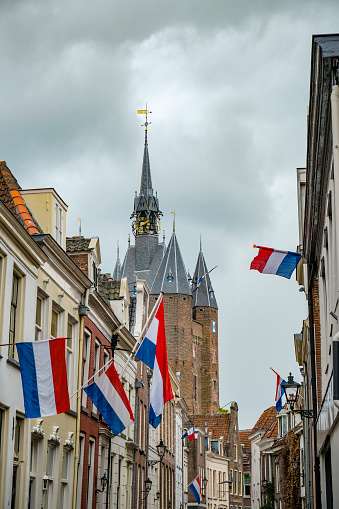 Dutch flags in the streets of Zwolle on liberation day, may 5th with the Sassenpoort in the background.