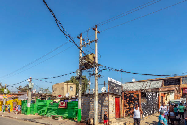 A man hooks up electricity lines to a transformer in southern Ethiopia.