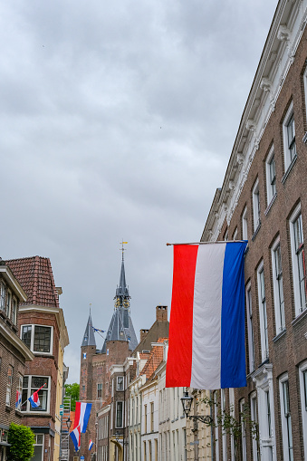 Dutch flags in the streets of Zwolle on liberation day, may 5th with the Sassenpoort in the background.