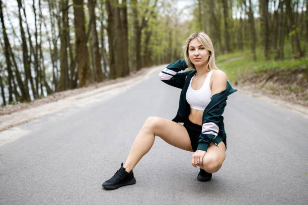 istock A young, pretty girl blonde is training before running outdoors. Sports activity. Exercise Outdoors. Health and benefits for the body 1150891239