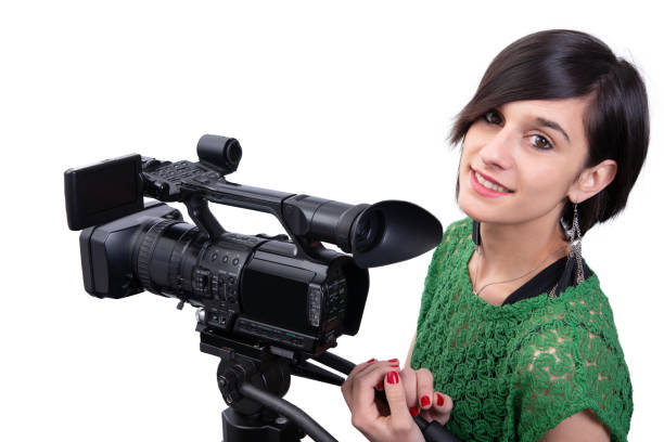 istock smiling young woman with professional video camera, isolated on white background 1150892192