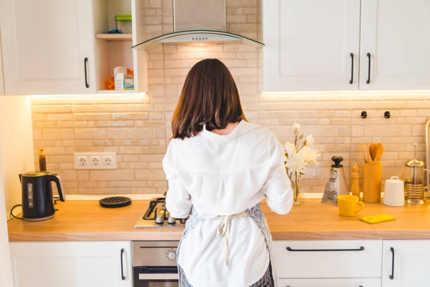 istock view from behind woman on kitchen cooking 1150892362