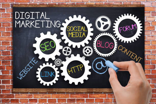Digital marketing concept with spinning gears on blackboard stock photo