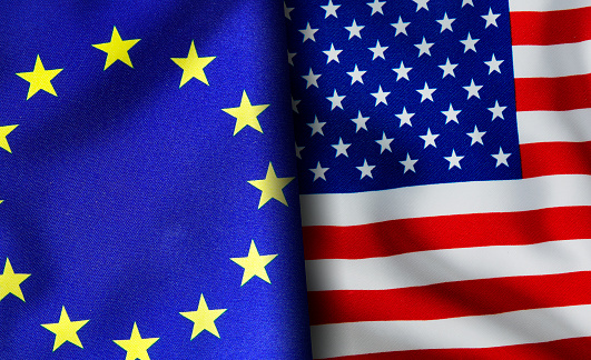 American and European union flags standing side by side