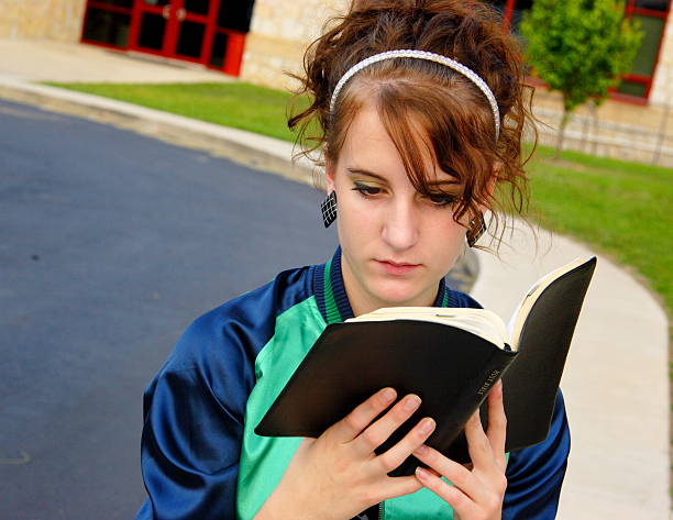 istock female teen student studying bible 115089462