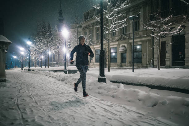 istock Woman jogging in winter night 1150894889
