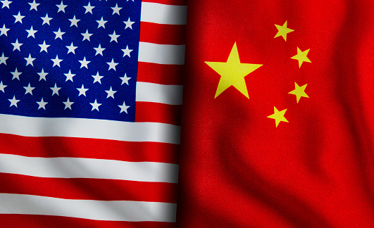 American and Chinese flags standing side by side
