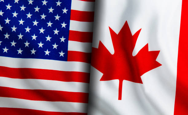istock American and Canadian flags standing side by side 1150895411