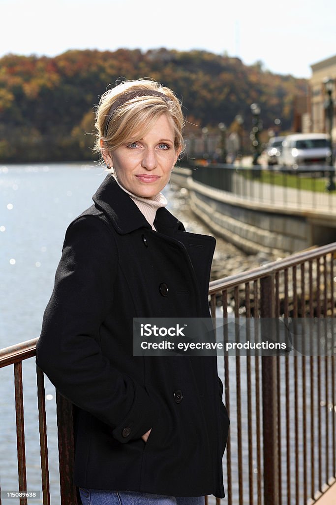 middle age beauty autumn portrait middle aged blonde beautiful woman outdoors on an autumn day near a boardwalk by a lake Adult Stock Photo