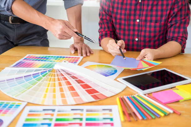 istock Midsection Of Colleagues Analyzing Color Swatch In Office 1150899480