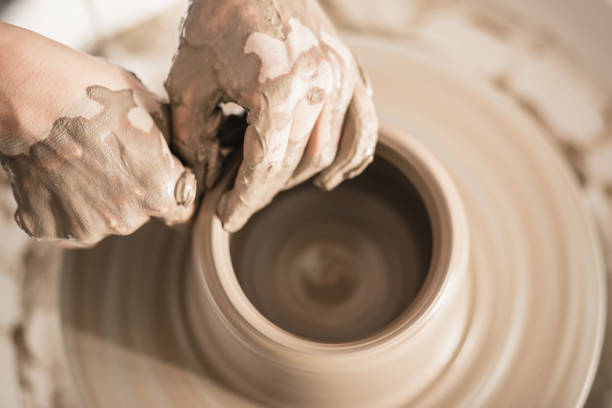 istock Close up of hands working on pottery wheel 1150899489