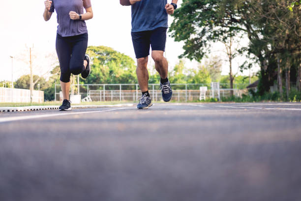 istock Low Section Of Friends Running On Road 1150899548