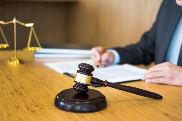 istock Midsection Of Lawyer Writing In Paper At Courthouse 1150899556