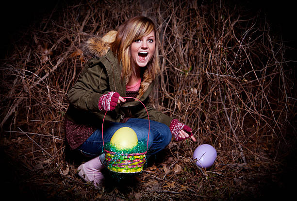 female teenager young person at Easter holding an egg