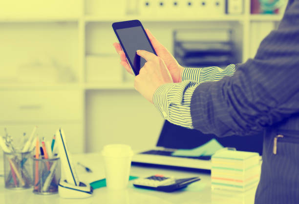 istock Hands of businesswoman using phone 1150902709