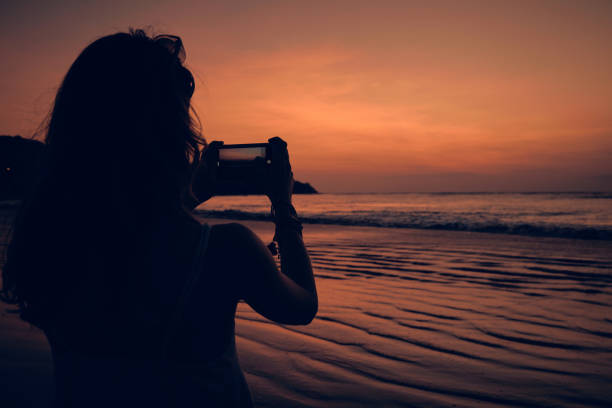 istock Woman using cellphone on a tropical ocean beach. 1150907075
