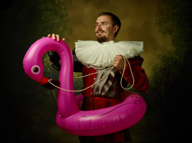 istock Young man as a medieval knight on dark background 1150907401