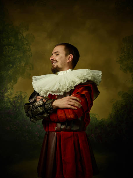 istock Young man as a medieval knight on dark background 1150907440