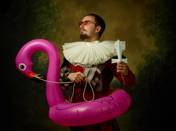 istock Young man as a medieval knight on dark background 1150907444