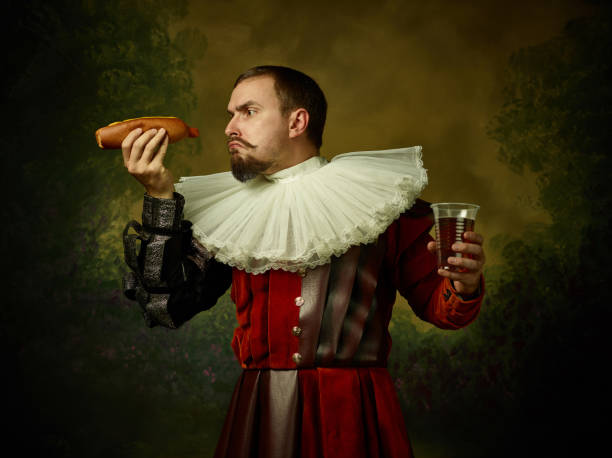 istock Young man as a medieval knight on dark background 1150907447