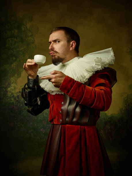 Young man as a medieval knight on dark background