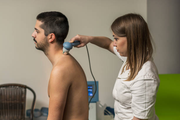 istock Physiotherapist treating patient with electrical stimulation. 1150907543