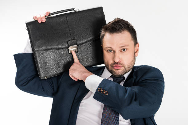 istock chubby businessman holding briefcase and looking at camera isolated on white 1150910055