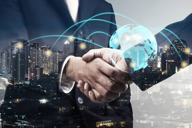 double exposure of businessmen handshake and global simulation connecting technology with blur city night and network connection, successful and partnership concept stock photo