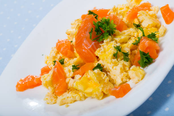 istock Cooked tasty omlette  fried with salmon served at plate on table 1150913030