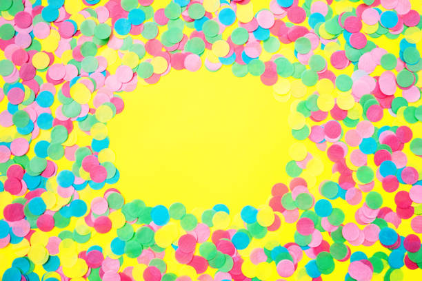 istock Multicolored confetti on a yellow background. Gala concert 1150913121
