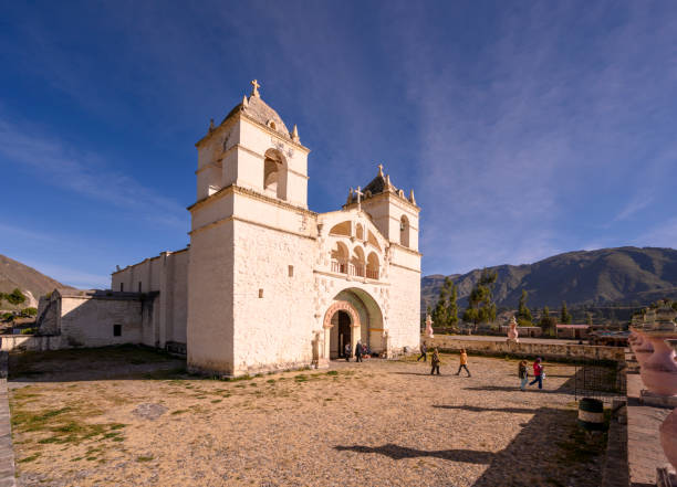 People visiting a church in Chivay at Colca Canyon in the Arequipa province in Peru during a cool morning.