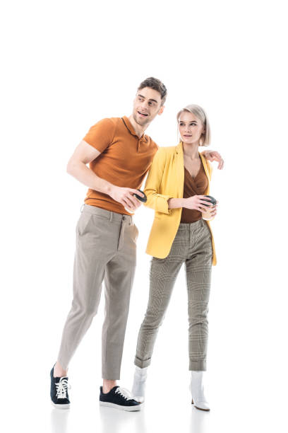 istock smiling young man and woman holding coffee cups while standing together isolated on white 1150913580