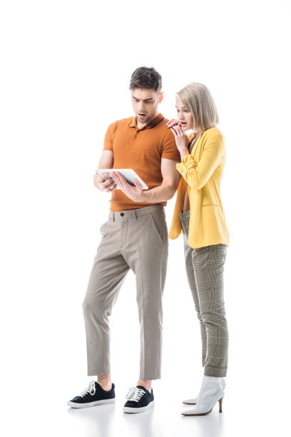 istock surprised young man and woman using digital tablet together isolated on white 1150913587