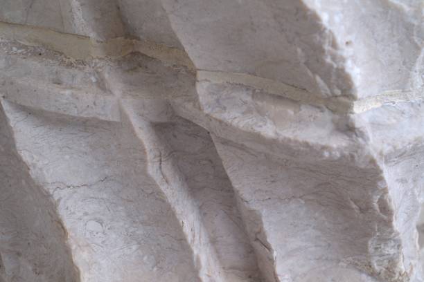 Closeup view of chiseled rock in old building facade stock photo