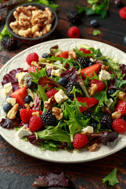 istock Fresh Fruit Salad with blueberry, strawberry raspberry, walnuts, feta cheese and green vegetables. healthy summer food 1150914802