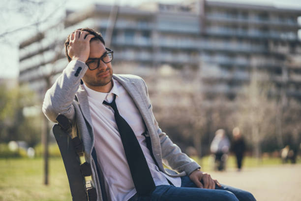 istock Tired businessman in park 1150916571