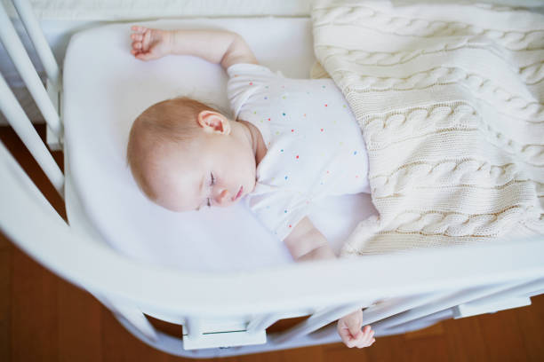 istock Baby sleeping in co-sleeper crib attached to parents' bed 1150916976