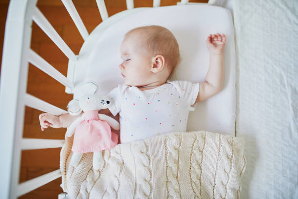istock Baby sleeping in co-sleeper crib attached to parents' bed 1150916984