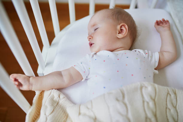 istock Baby sleeping in co-sleeper crib attached to parents' bed 1150917036