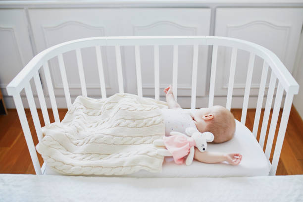 istock Baby sleeping in co-sleeper crib attached to parents' bed 1150917057
