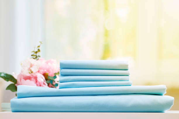 istock Closeup stack of blue clean bedding on the table. Blurred background. 1150917133