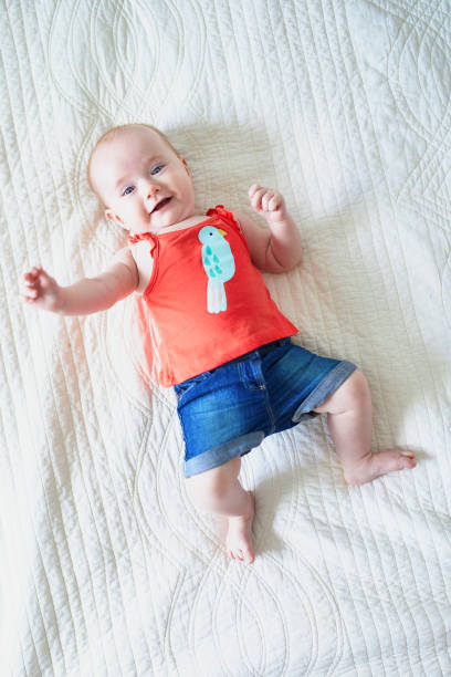 istock Six months old baby girl lying on her back 1150917776