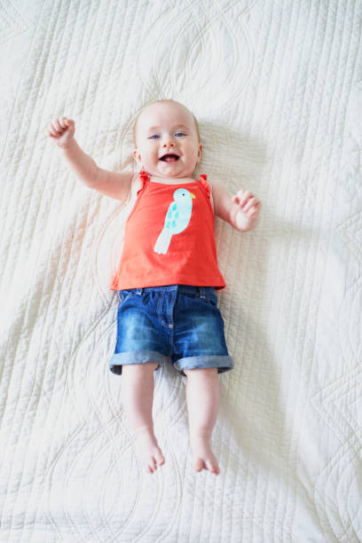 istock Six months old baby girl lying on her back 1150917787