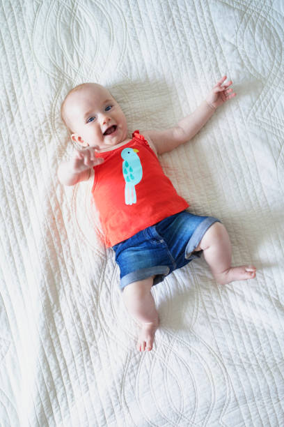 istock Six months old baby girl lying on her back 1150917802